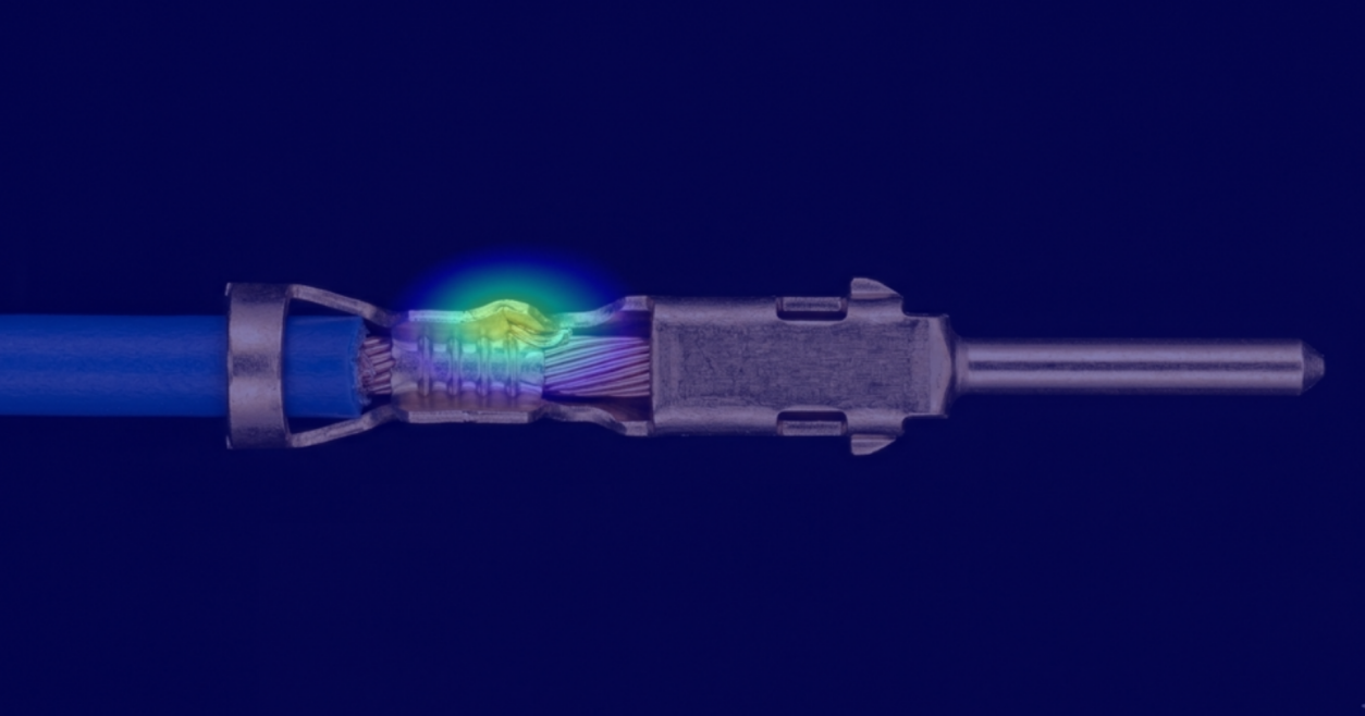 An illustration of defect detection in cable crimping showing the anomalous area highlighted in bright colour.